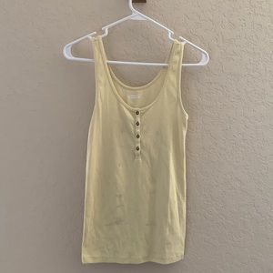 A yellow button up tank top.